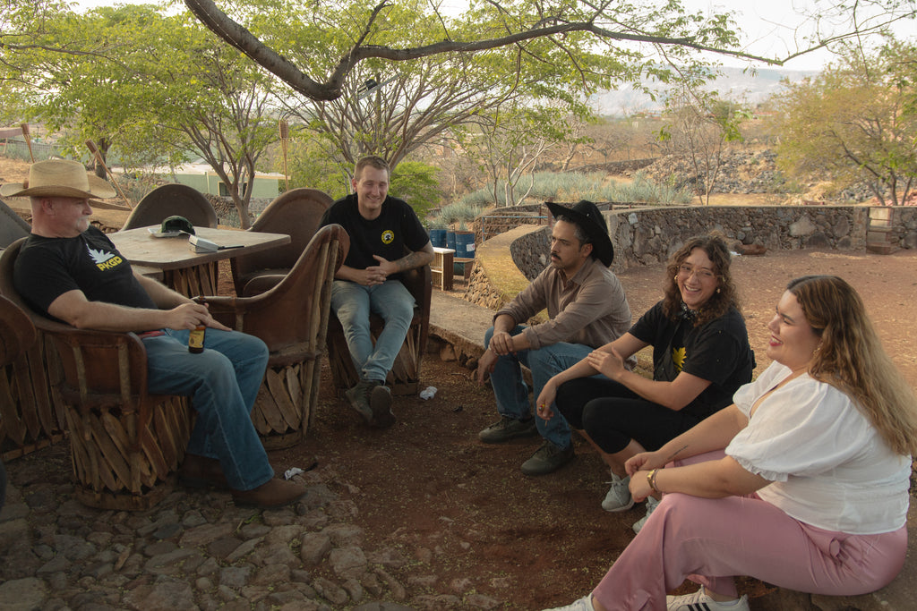 Group of people sitting outdoors in a natural setting